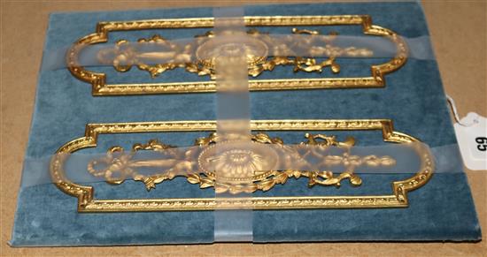 Pair of decorative ormolu finger plates mounted on velvet-covered panel